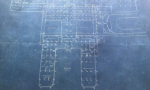 Building blueprints with a dark background and elements of the building in light color.
