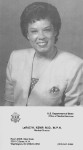 A black and white photograph of LaRae Kemp wearing a light-colored blazer with a pocket-square and short, curly hair.