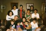 A group photo of LaRae Kemp, her husband, Tyrone, and several of their grandchildren sitting on a couch in 1997.