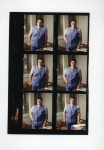Six small headshots of Dr. Bonnie Camp wearing matching purple vest and pants with a striped short-sleeved blouse. She stands beside a chair with one hand resting on an open notebook on a desk, smiling at the camera.