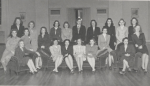 Black-and-white group portrait of the junior honor society, The Torch, at Mississippi State College for Women. The women are seated and standing in skirt suits.