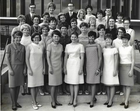 A group photo of the University of Colorado's Class of 1967 Physical Therapy students. LaRae Kemp is in the front row, third from the right in a geometric patterned knee length dress and black heels.