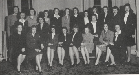 Black-and-white group portrait of the women in the sophomore honor society, The Lantern, at Mississippi State College for Women in 1947. The women are primarily dressed in dark skirt suits.
