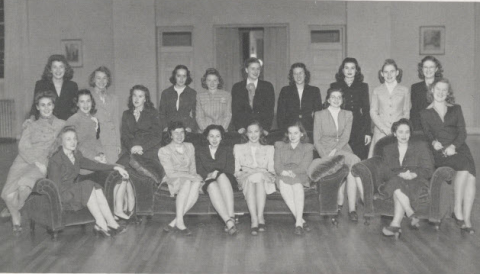 Black-and-white group portrait of the junior honor society, The Torch, at Mississippi State College for Women. The women are seated and standing in skirt suits.