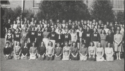 Black-and-white group portrait of the Women's Athletic Association at Mississippi State College in 1946. Most women wearing dark colored sweaters with the letter M.