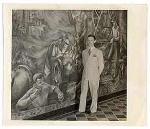 Photo of Edgar Britton next to wall mural