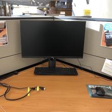Workstation showing monitor, cords, keyboard, and mouse.