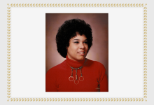 Dr LaRae Kemp; black woman wearing a red turtleneck with a beaded necklace