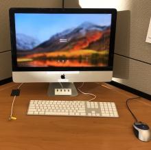 Workstation showing iMac computer with keyboard and mouse