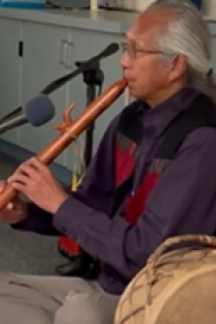 Joseph Medicine Robe playing a traditional Native flute.